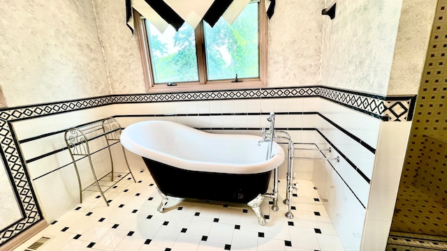 bathroom featuring tile walls and a bathtub