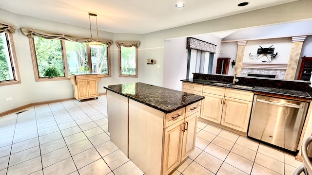 kitchen with a kitchen island, stainless steel dishwasher, dark stone counters, decorative columns, and pendant lighting