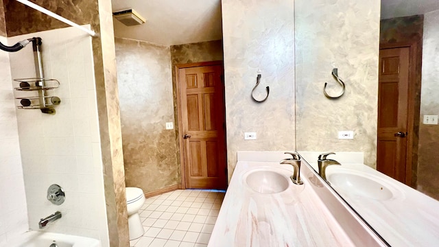 full bathroom featuring vanity, tiled shower / bath combo, toilet, and tile patterned floors