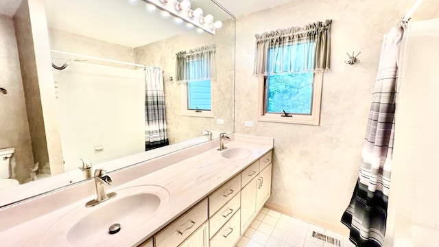 bathroom with vanity, toilet, tile patterned floors, and a shower with shower curtain