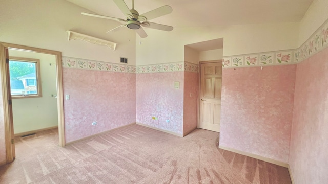 carpeted empty room with lofted ceiling and ceiling fan