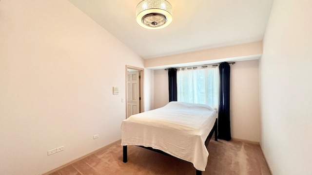 carpeted bedroom featuring lofted ceiling