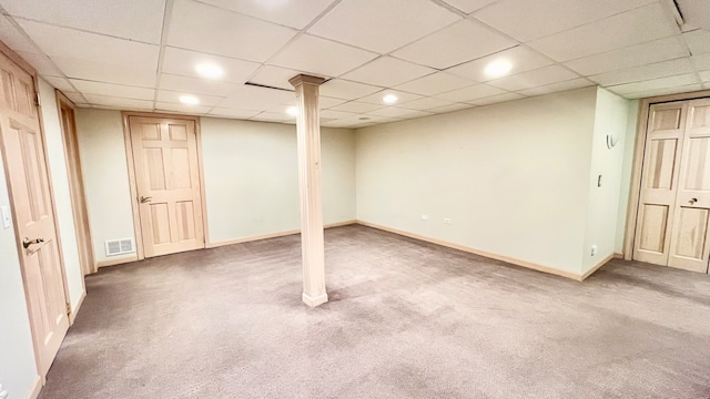 basement with carpet floors and a drop ceiling