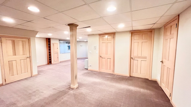 basement featuring a drop ceiling and carpet floors