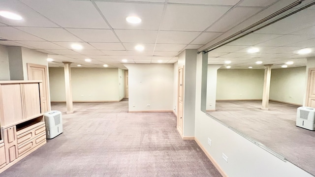 basement featuring carpet and a drop ceiling