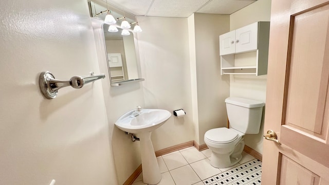 bathroom featuring toilet and tile patterned flooring