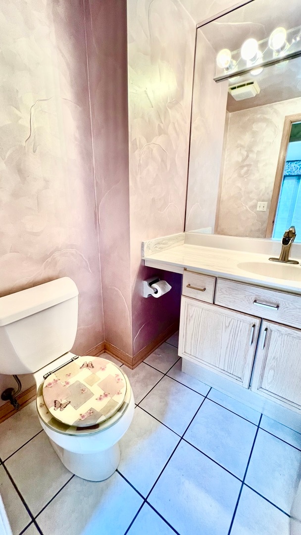 bathroom featuring vanity, toilet, and tile patterned flooring