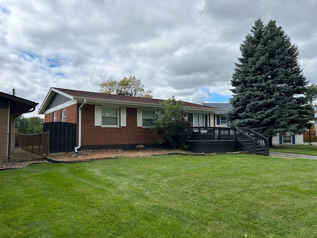 single story home featuring a front yard and a deck