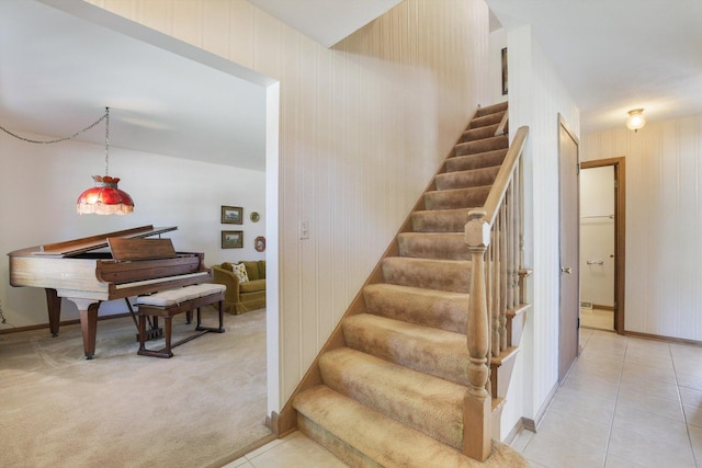 stairway featuring carpet floors