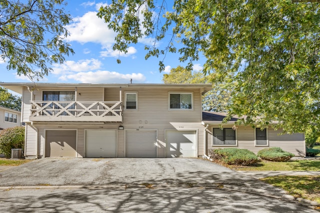 view of front of house with central AC and a garage