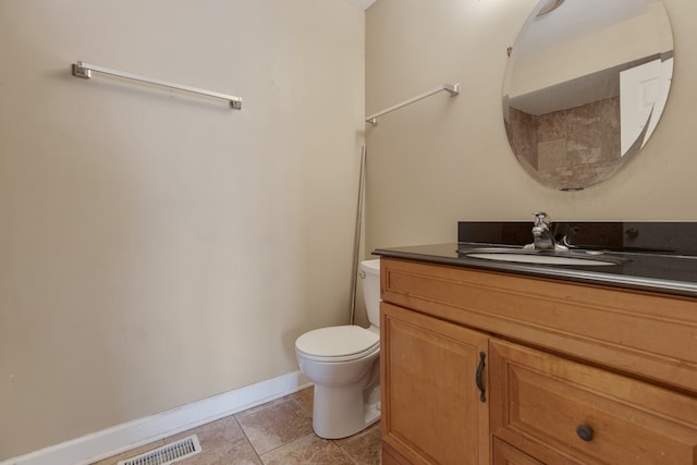 bathroom featuring vanity, toilet, and tile patterned flooring