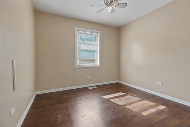 empty room with dark wood-type flooring and ceiling fan