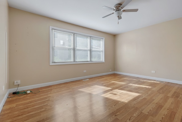 empty room with light hardwood / wood-style flooring and ceiling fan