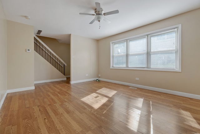 unfurnished living room featuring a wealth of natural light, light hardwood / wood-style flooring, and ceiling fan