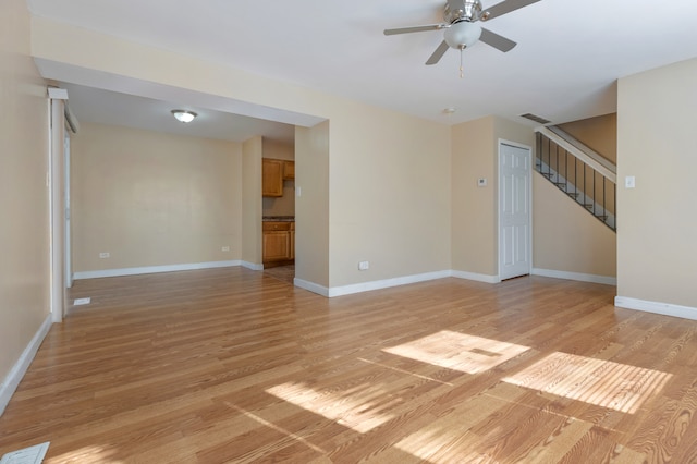 unfurnished living room with light hardwood / wood-style floors and ceiling fan