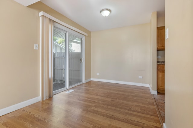 unfurnished room with wood-type flooring