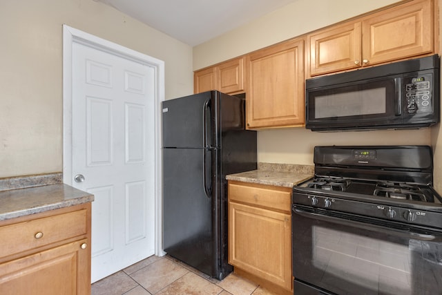 kitchen with black appliances, light brown cabinets, and light tile patterned floors