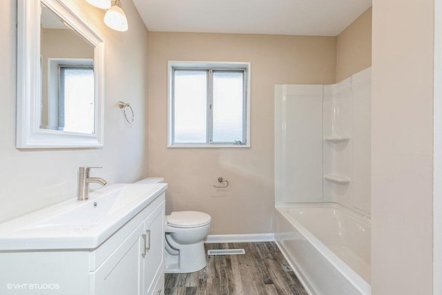 bathroom featuring visible vents, wood finished floors, vanity, baseboards, and toilet