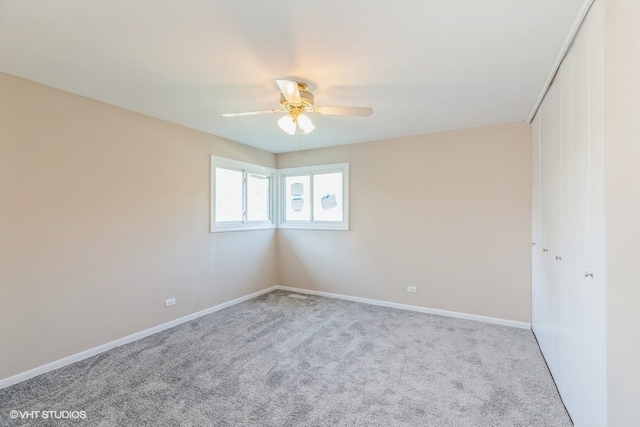 spare room with light carpet and ceiling fan