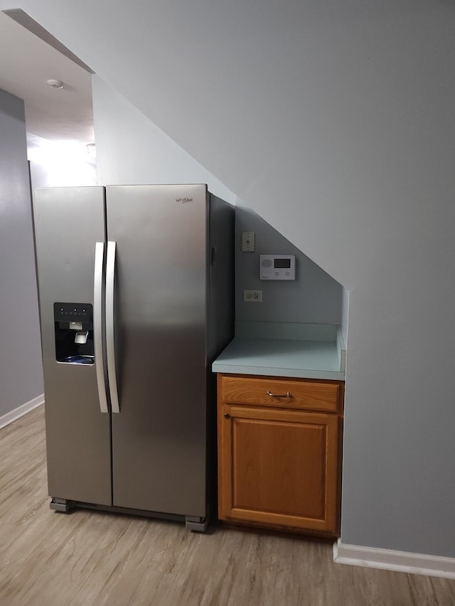 kitchen featuring stainless steel refrigerator with ice dispenser and light wood-type flooring