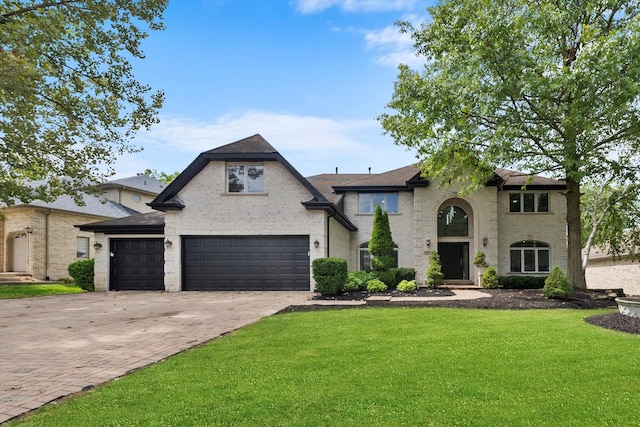 view of front of house featuring a front lawn and a garage