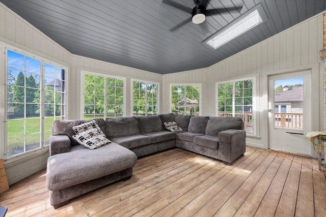 sunroom with vaulted ceiling with skylight, ceiling fan, and plenty of natural light