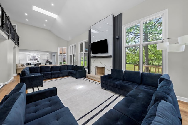 living room featuring hardwood / wood-style floors and high vaulted ceiling