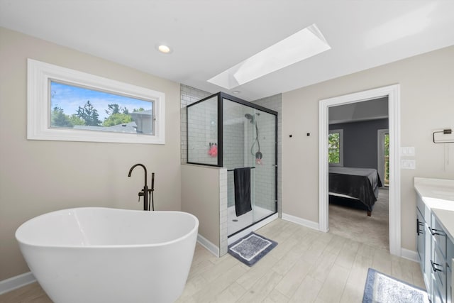 bathroom featuring vanity, a healthy amount of sunlight, shower with separate bathtub, and wood-type flooring