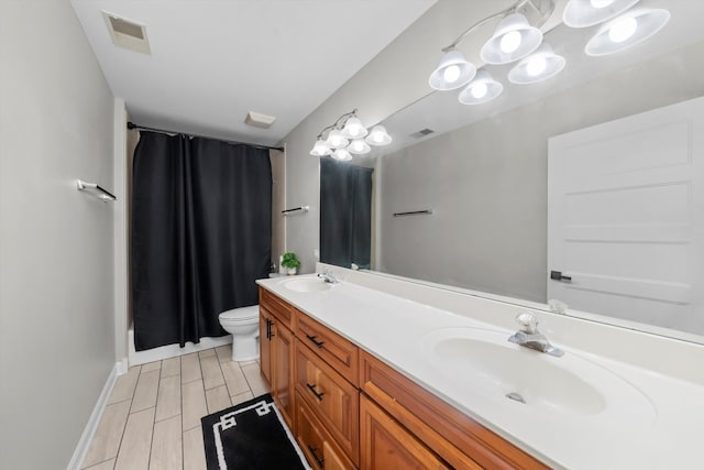 bathroom featuring vanity, toilet, and walk in shower