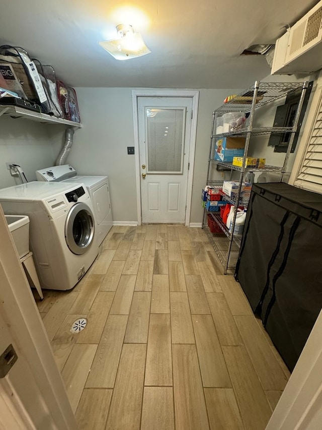 laundry area featuring light hardwood / wood-style floors and washer and clothes dryer