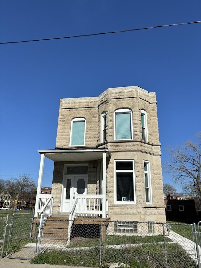 view of front of home featuring a fenced front yard and a porch