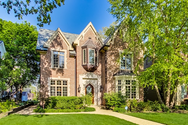 tudor house featuring a front yard