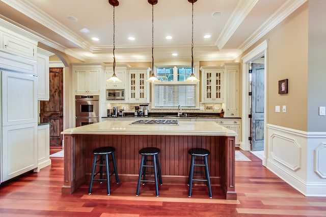 kitchen featuring a breakfast bar, stainless steel appliances, a center island, and pendant lighting