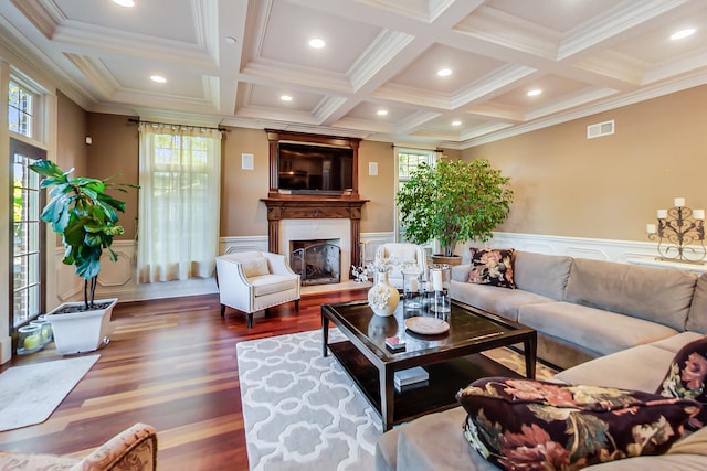 living room featuring beam ceiling, ornamental molding, and dark wood-type flooring