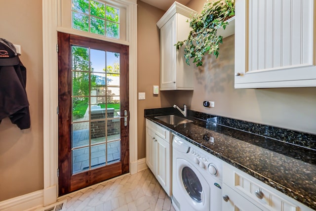 laundry room featuring washer / dryer, light tile patterned flooring, cabinets, and sink