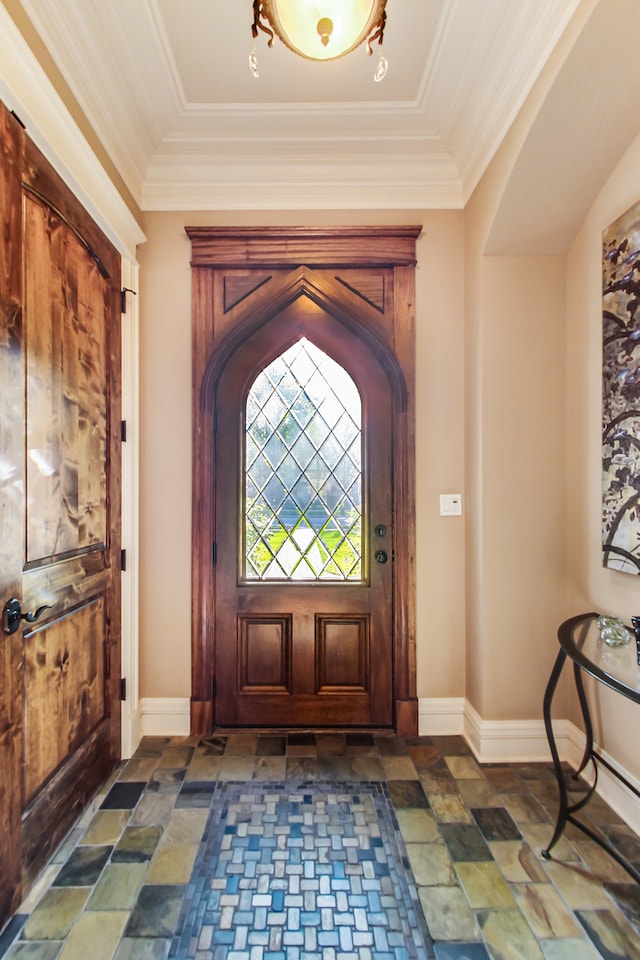 entrance foyer with crown molding and a tray ceiling