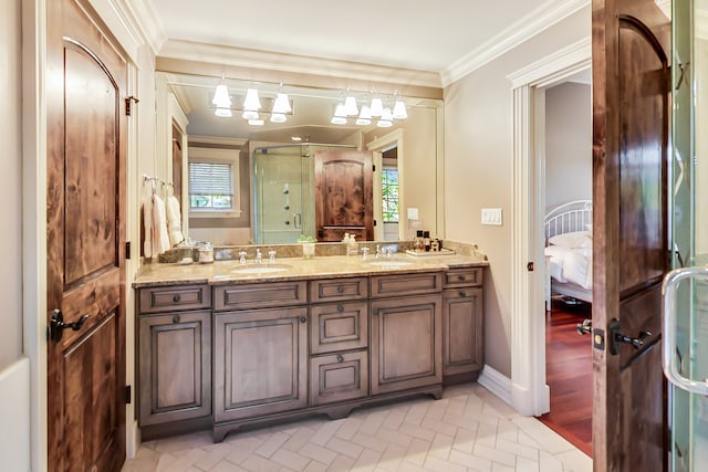 bathroom with a wealth of natural light, vanity, crown molding, and a shower with door