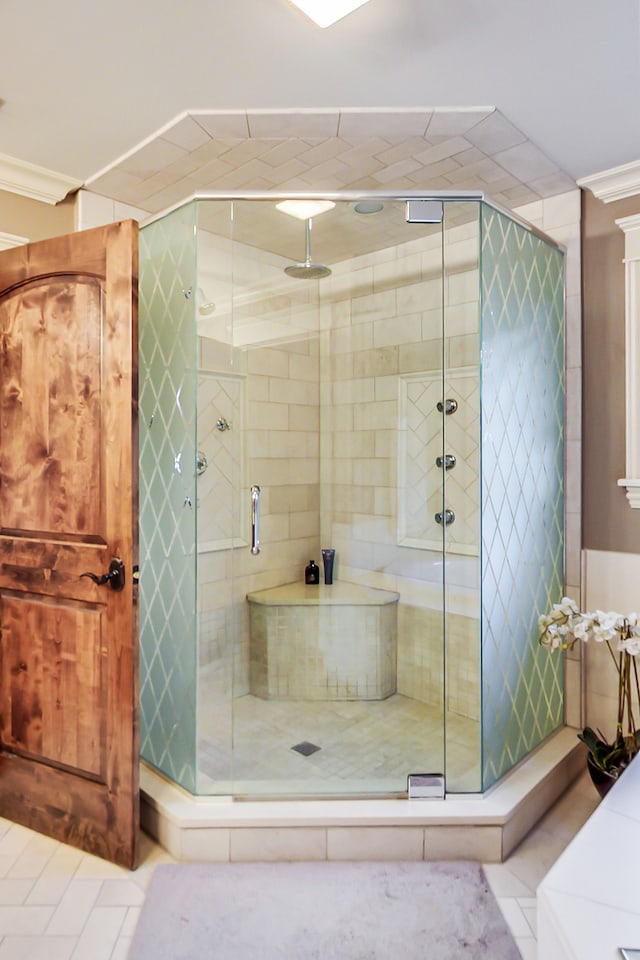 bathroom featuring walk in shower and tile patterned floors