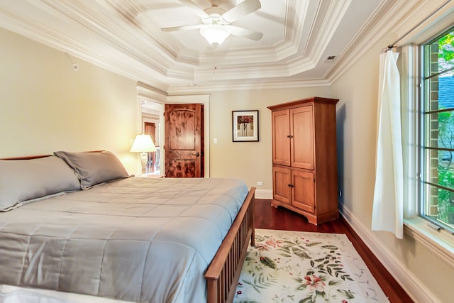 bedroom with ceiling fan, crown molding, multiple windows, and dark hardwood / wood-style flooring