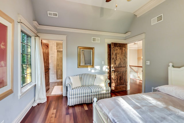 bedroom with connected bathroom, vaulted ceiling, ornamental molding, and dark hardwood / wood-style flooring