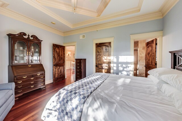 bedroom featuring dark wood-type flooring, crown molding, and a tray ceiling