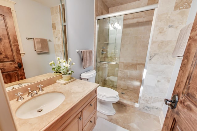 bathroom featuring vanity, toilet, tile patterned floors, and an enclosed shower