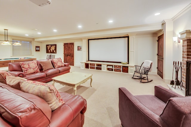 cinema room with pool table, ornamental molding, light colored carpet, and a brick fireplace