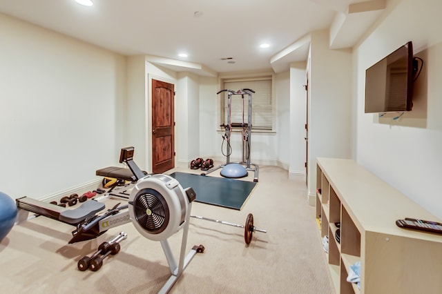 exercise room featuring light carpet