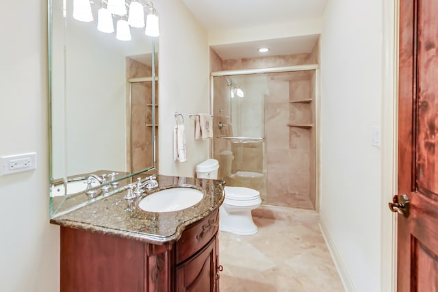 bathroom featuring vanity, toilet, and walk in shower