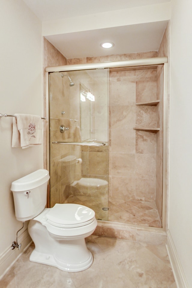 bathroom with tile patterned floors, toilet, and walk in shower