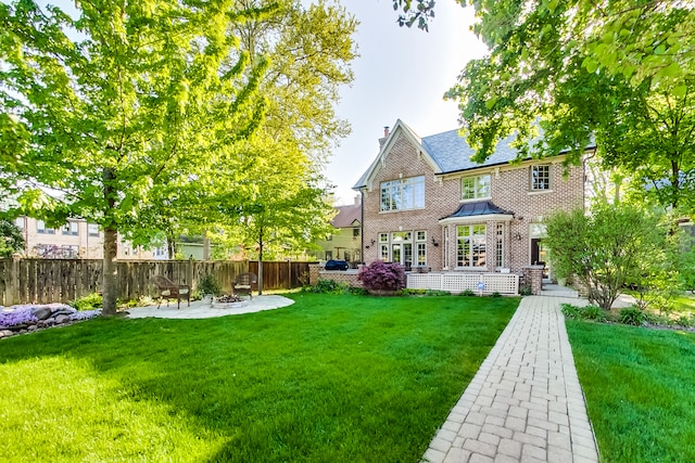 back of house with a yard and a patio area