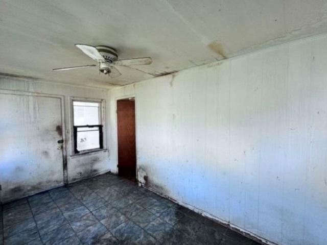 2654 W 98th Pl, Evergreen Park, IL 60805 - empty room with ceiling fan and wooden walls
