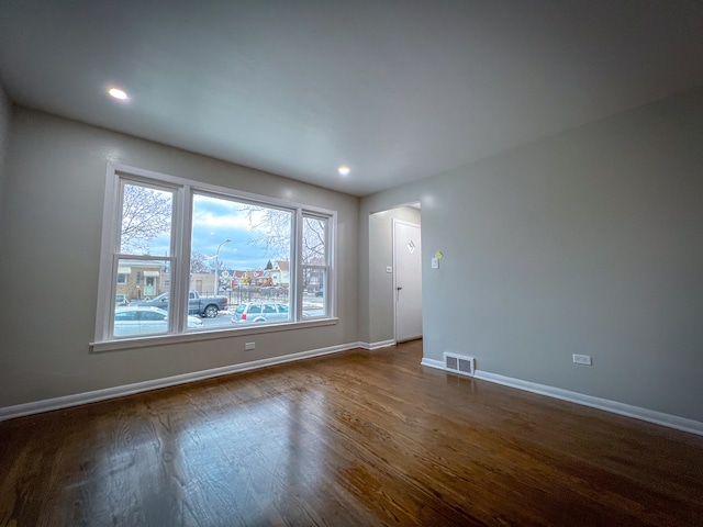 empty room with dark wood-type flooring