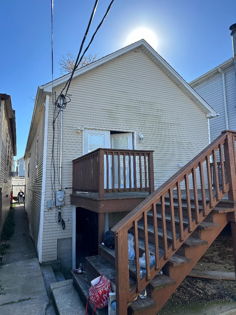 rear view of house featuring a deck